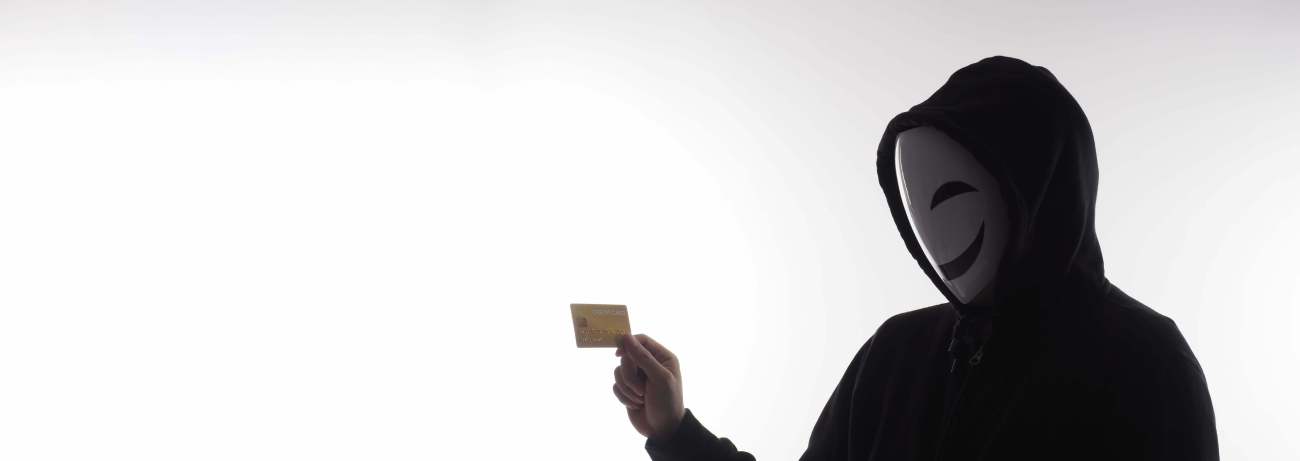 Criminal holding card after stealing information 